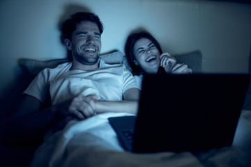 man sitting on sofa with laptop computer