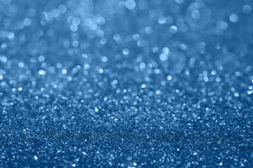 Abstract composition. Classic blue glitter light background with beautiful bokeh. Color of the year 2020