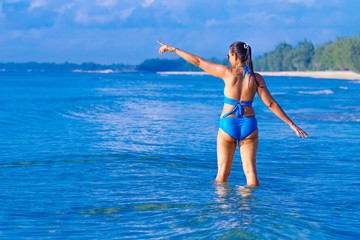 Woman and bikini blue sexy jump on wave at beach