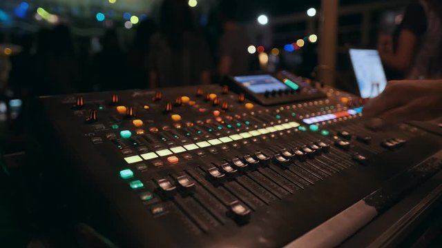 Light panel DJ remote control laser show. Night club performance music group and laser show. DJ twists arms levers, close-up. Nightclub Party. Lifestyle. Popular Disco Trends 70s, 80s, 90s