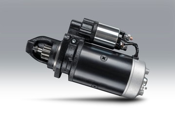 3kW starter motor for tractor or other agricultural machinery placed on gray isolated background...