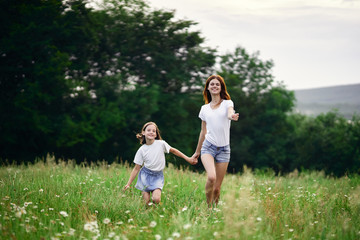 mother and daughter running in the park