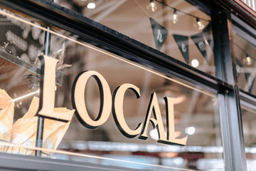 'Local' text on shop-window in Granville island public market