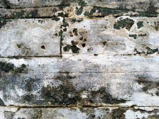 Abstract texture of mossy, porous, cracked and weathered sandstone walls. Wall texture can be used as a wall frame and wall background. Dirty and Old sandstone wall texture background.