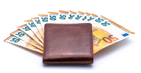 Brown leather wallet on top of cash euro notes. Money saving concept isolated on white background.
