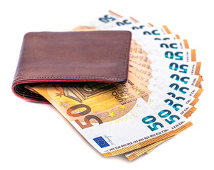Brown leather wallet on top of cash euro notes. Money saving concept isolated on white background.