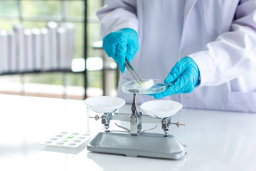 Researchers are weighing tablets in the laboratory.