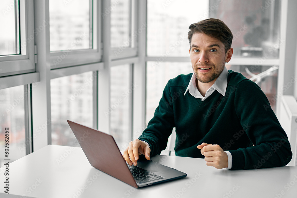 Wall mural businessman working on laptop in an office