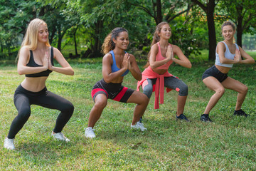 female friends having workout together in park