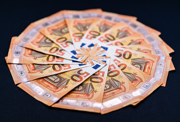 Euro cash money in notes. Studio shot isolated on black background. High fifty paper notes only.  European currency.