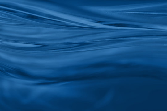 Abstract blurred soft focused futuristic dark blue wavy background. 2020 trend color concept