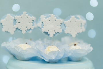 Obraz na płótnie Canvas Studio shot of topped coconut candy with snowflakes symbol. Decoration of children's parties with tasty candies. Selective focus.