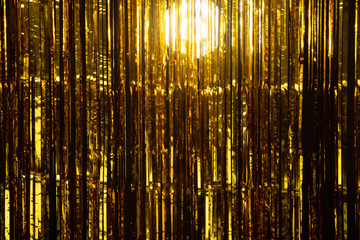 Gold Foil strip Curtain hanging on wall with studio lighting, Golden decorate Wallpaper Background...