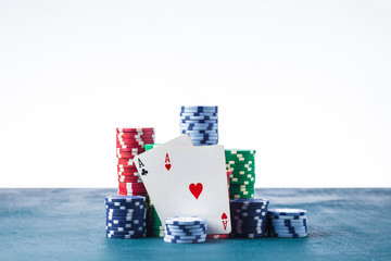 stack of poker chips with two aces on a white background isolate