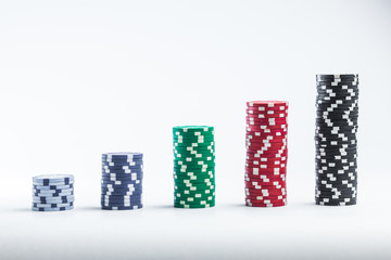 Poker chips on a white background different stacks
