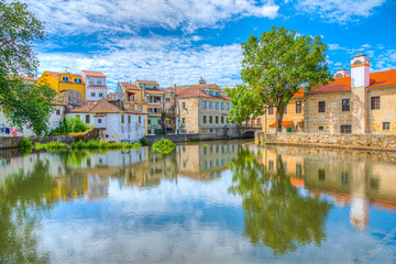 Old buildings in Viseu reflected on a local creek, Portugal