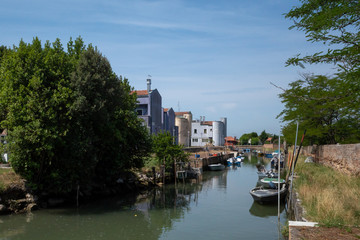 Fototapeta premium River with boats and buildings on island of Mazzorbo, by Burano, Venice, Italy