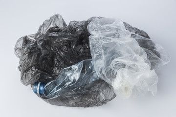 Plastic bags and crumpled bottles on a light background