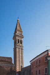 Fototapeta na wymiar Bell tower over colourful houses on island of Burano, Venice, Italy
