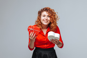 red-haired girl received a gift heart box