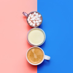 Classic blue and living coral with different types of hot drinks - coffee, matcha, cocoa and white creamers with milk and cream. Color of the year 2020.