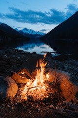 Close-up of campfire next to the lake in the evening after sunset in Canada - 307542456