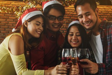 Group of friends having drink and fun  holding glasses of champagne at  Christmas party. 