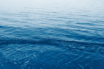 Obraz premium Color trend 2020. Surface of sea water colored by sunset light.