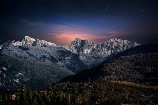Summit of the Rocky Mountains from the viewpoint in Grand Lake, Colorado, USA under a twilight starlit sky,