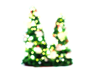 Abstract blurry two pine trees with bokeh of light bulb decoration on white color.