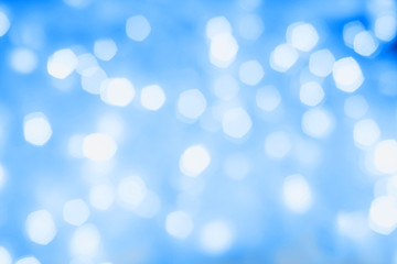 Fototapeta premium Blurred blue sparkling festive bokeh background. Trendy 2020 year color