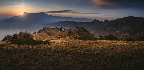 Sun hides behind the mountains. Beautiful sunrise or sunset. Scenic view