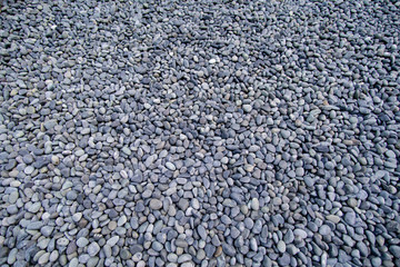 Well-groomed dark gray pebble, small stones.