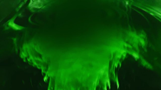 Paint fall into water which is twist. Spin acrylic ink drip into liquid. Visual effect bullet time, frozen moment, flow motion. Cloud fraction of color is spray drop. Slow motion cosmic video magic.