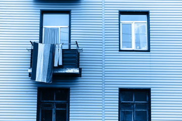 One towel hang on balcony of house, color of the year, blue photo.