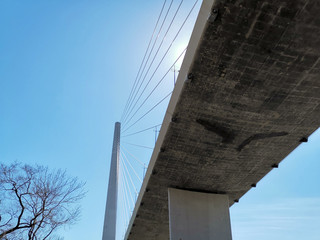 Bottom view of the Golden bridge against the blue sky.
