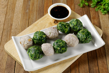 Chinese Chive Dumplings,Steamed Dumpling stuffed with Garlic Chives and Taro on white plate with sauce