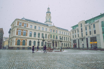 City Riga, Latvia. Old city center. Snowstorm wuth peoples and architecture.