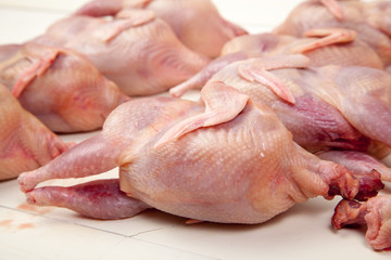 Raw quail meat on a wooden background - 307550625