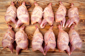 Raw quail meat on a wooden background - 307550646