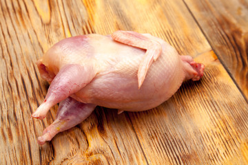 Raw quail meat on a wooden background - 307550667