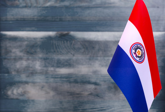 Fragment of the flag of Paraguay in the foreground blurred light background copy space
