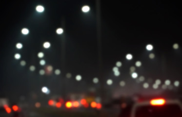 Abstract blurred image of road at night time with vehicle light bokeh for background usage, City road vehicles and heavy traffic moving at speed. 