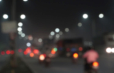 Abstract blurred image of road at night time with vehicle light bokeh for background usage, City road vehicles and heavy traffic moving at speed. 