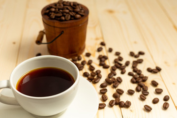 cup of coffee and beans on wooden table