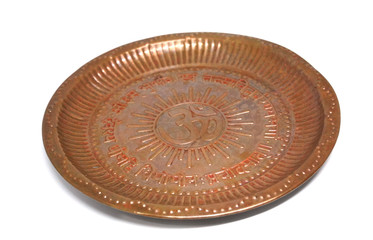 Traditional Indian copper plate isolated on white background, Copper dish with Om hindu sign on white with shadow.