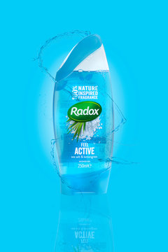 SWINDON, UK - MARCH 3, 2019: Radox Sea Salt and Lemon Grass Shower Gel on a light blue and water splashed background