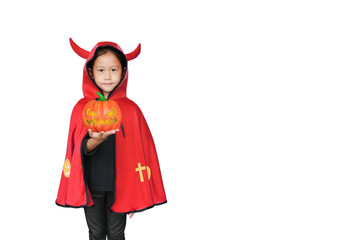 Beautiful little Asian child girl dressed Halloween costume with holding magic pumpkin in hand. Kid in red Dracula robe isolated on white background with copy space.