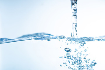 Water splash. Aqua flowing in waves and creating bubbles. Drops on the water surface feel fresh and...