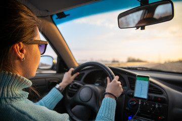 car travel concept sunrise at winter highway navigation on phone
